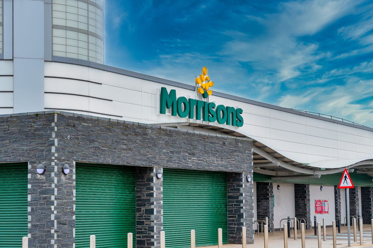 Green powder-coated roller shutters matched to the brand at a Morrisons supermarket