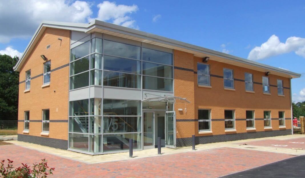 Corner curtain walling feature and glazed entrance on a two-storey commercial office