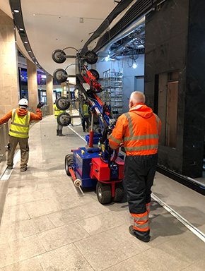 Engineers installing a commercial shopfront and shutter on site